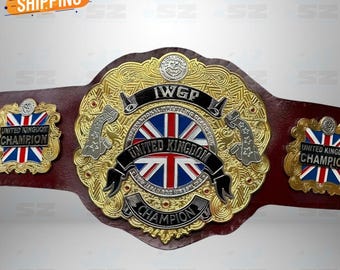 May include: A gold and red wrestling championship belt with the text "IWGP" and "United Kingdom Champion". The belt features the Union Jack flag and ornate detailing. The belt is made of metal and leather.