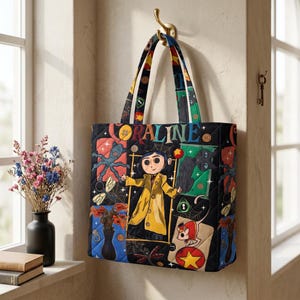 May include: A quilted tote bag featuring a colorful graphic print of the character Coraline in a yellow raincoat, surrounded by illustrations of a black cat, a mouse, spiderwebs, and buttons, with the text CORALINE printed across the top.
