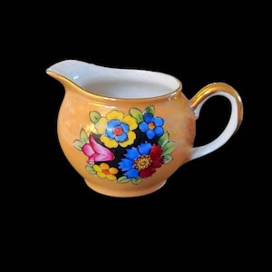 Beautiful Noritake little lusterware creamer with floral design.