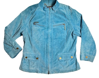 May include: A light blue suede jacket with a zip-up front, two chest pockets with zippers, and two lower flap pockets with button closures. The jacket has long sleeves with buttoned cuffs and a stand-up collar.