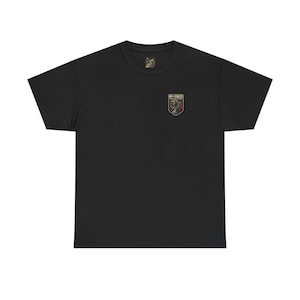 May include: Black t-shirt with a small embroidered emblem on the upper left chest. The emblem features a shield design with text and floral elements. The shirt is made of a soft, comfortable material.