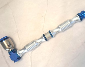 Silver and blue metal pipe with lid.