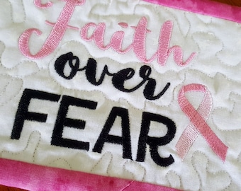 Quilted mug rug with embroidery stitching the breast cancer logo faith over fear,   Pink and white mini quilt, pink breast cancer ribbon