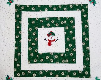 Christmas quilted wall hanging, table mat, topper or quilt featuring embroidered snowman and holly in each corner.  hanging sleeve attached