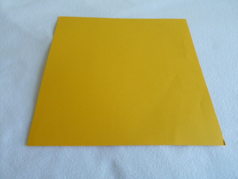 May include: A solid yellow sheet of paper.