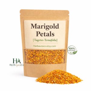 May include: A kraft paper bag filled with dried marigold petals, with a pile of petals in front. The bag has a label that reads "Marigold Petals [Tagetes Tenuifolia]" and "100% Organic". The Etsy shop name "Herbauraco.etsy.com" is also visible.