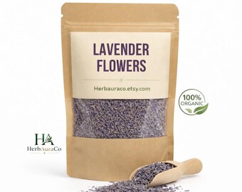 May include: A brown paper bag filled with dried lavender flowers. The bag has a white label with the text "LAVENDER FLOWERS" and "Herbauraco.etsy.com". A wooden scoop and scattered lavender flowers are in front of the bag. A green "100% ORGANIC" logo is on the right.