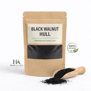 May include: A kraft paper bag with a clear window displaying black walnut hull. The bag has a white label with the text "BLACK WALNUT HULL" and "Herbauraco.etsy.com". A wooden scoop and a pile of black walnut hull are in front of the bag. A green "100% ORGANIC" logo is on the right.