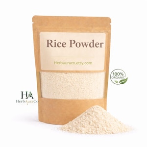 May include: A brown paper bag of rice powder with the text "Rice Powder" on the front. A small pile of rice powder sits in front of the bag. The bag also has the text "Herbauraco.etsy.com" and a "100% Organic" logo.