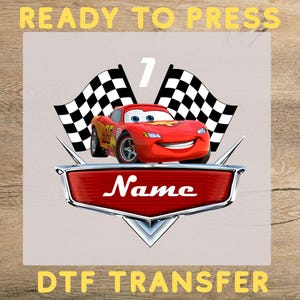 May include: A red cartoon race car with the number 95 on the side, smiling, with two checkered flags and the number 7. The word "Name" is in white on a red shield. The words "READY TO PRESS" and "DTF TRANSFER" are in yellow.