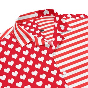May include: Red and white button-down shirt with a heart and stripe pattern. The shirt features a repeating pattern of white hearts on a red background on one side and red and white stripes on the other.