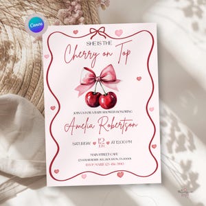 May include: Baby shower invitation in pink and red. The design includes the text "She is the Cherry on Top" with a cherry and bow illustration. The invitation is for Amelia Robertson, with details of the event.