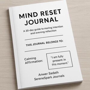 May include: A white journal titled "Mind Reset Journal" with black lettering. It's a 30-day guide for morning intention and evening reflection. Includes a space to write "This Journal Belongs To:" and a calming affirmation: "I am fully present in this moment."