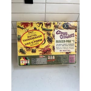 May include: A vintage Mattel Creepy Crawlers Maker-Pak #1 toy box with a yellow background featuring illustrations of various insects. The box includes text detailing its use with Mattel Thingmaker or Vac-U-Form machines and contents.