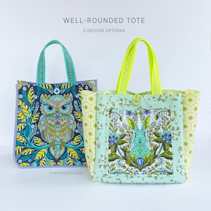 Könnte beinhalten: Zwei Tragetaschen mit einzigartigen Designs. Eine zeigt eine Eule, die andere ein Kaninchen, beide vor floralen Hintergründen. Die Taschen haben kontrastierende Griffe und der Text "WELL-ROUNDED TOTE" und "2 DESIGN OPTIONS" ist sichtbar.