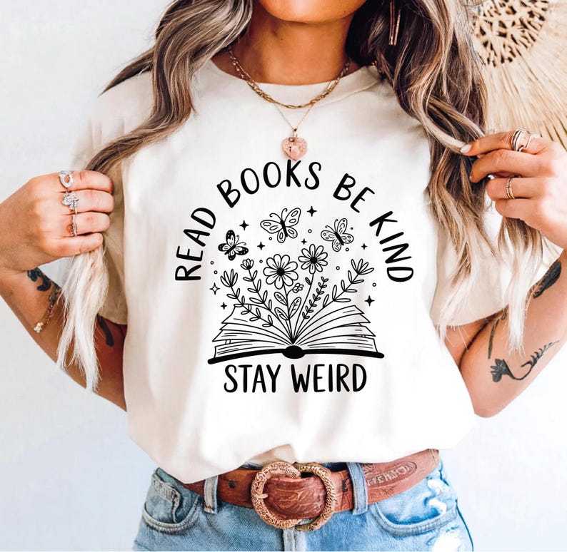 A woman wearing a white t-shirt with a graphic design and text printed on it.