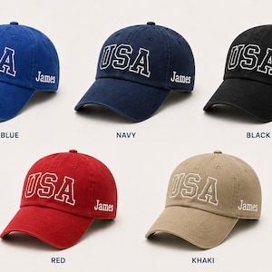 a collection of six baseball caps, each with a different color and design, all featuring the word "USA" prominently displayed.