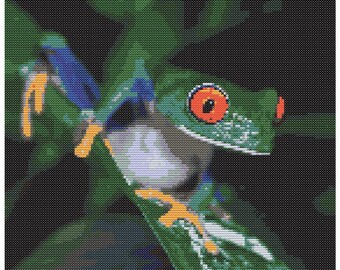 May include: Cross-stitch pattern of a red-eyed tree frog. The frog is green with blue and orange accents, perched on a green leaf. The frog has large, orange eyes. The design size is 142 x 132 stitches.