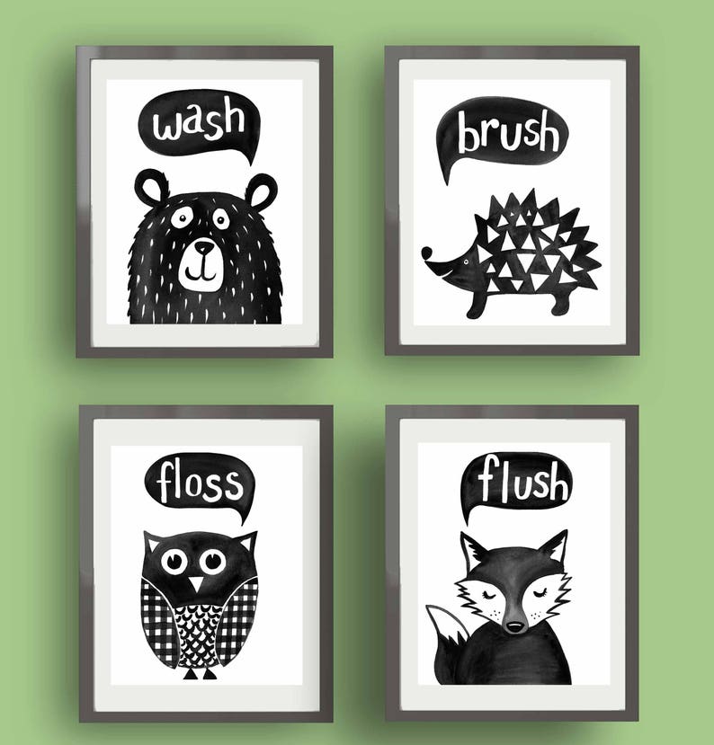 May include: Four black and white framed prints with animal illustrations and bathroom-related words. The prints feature a bear with the word "wash", a hedgehog with the word "brush", an owl with the word "floss", and a fox with the word "flush".