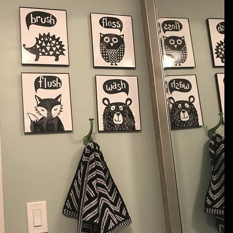 May include: Black and white bathroom signs with animal illustrations and text that says "brush", "floss", "flush", "wash", "floss", "wash".