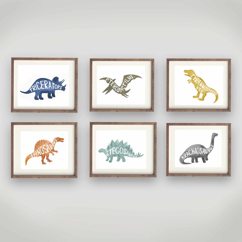 May include: Six framed watercolor dinosaur prints with the dinosaur's name written inside the silhouette. The prints are in a variety of colors, including blue, green, orange, and yellow.