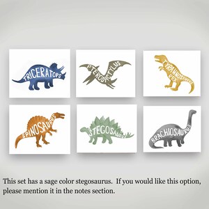 May include: Set of six watercolor dinosaur prints with the dinosaur names spelled out within the silhouette of each dinosaur. The dinosaurs are Triceratops, Pterodactyl, Tyrannosaurus Rex, Spinosaurus, Stegosaurus, and Brachiosaurus.