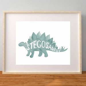 May include: A watercolor illustration of a teal green stegosaurus with the word "STEGOSAURUS" written in white inside the dinosaur's silhouette.