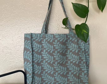 Bolsa de lona con estampado de hojas para organizar proyectos de punto en proceso.