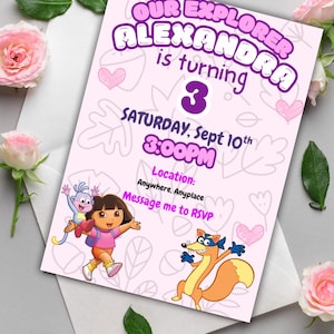 May include: A light pink birthday invitation featuring Dora the Explorer characters. The invitation reads "Our Explorer Alexandra is turning 3" with the date and time. Pink hearts and leaf designs decorate the background.