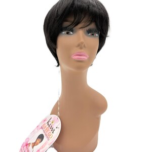 May include: A black wig styled in a short, layered cut, displayed on a mannequin head. The wig features a side-swept bang and is designed for easy wear. A tag with the text "Kiwi Easy Go" is attached.