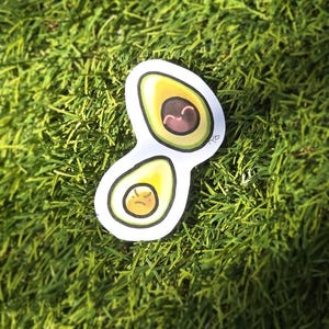 May include: A white ceramic mug with a black handle and the text "But First, Coffee" in a black, bold font. The mug is on a white surface.