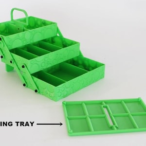May include: A bright green, three-tiered storage box with a handle and a separate sorting tray. The box has a textured surface with a repeating pattern. The text "SORTING TRAY" is visible.