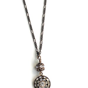 Brass art deco crystal pendant with Swarovski crystal round pendant with three tiers of Swarovski crystals suspended from a brass Swarovski crystal ball. Antique brass chain in 16, 18 or 20 inches. Lobster clasp with Nickel and lead free chain.