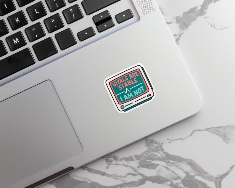 May include: A sticker with the text "VITALS ARE STABLE I AM NOT" in a retro-style design. The sticker features a teal and pink color scheme, with a monitor graphic and a heartbeat line.