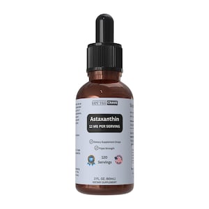 May include: A brown glass bottle of Astaxanthin dietary supplement drops with a black dropper. The label reads "12 MG PER SERVING" and "120 Servings". The bottle contains 2 fl oz (60mL) of liquid.