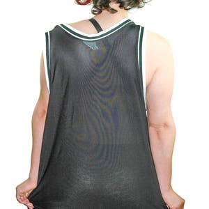 May include: A black mesh tank top with white trim around the neck and armholes. The tank top is loose fitting and appears to be made of a lightweight material.