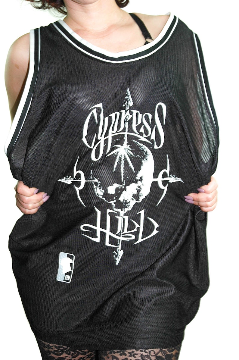 May include: Black mesh basketball jersey with a white skull and crossbones graphic and the text "Cypress Hill".