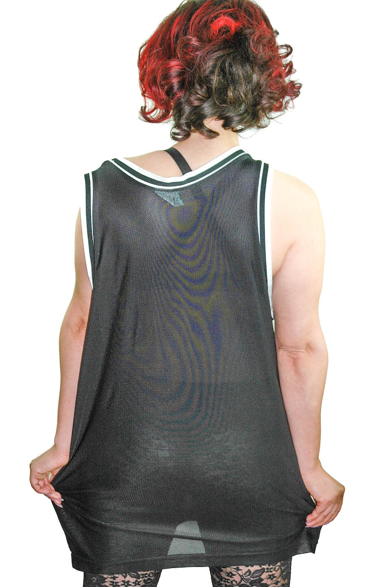 May include: A black mesh tank top with white trim around the neck and armholes. The tank top is loose fitting and appears to be made of a lightweight material.