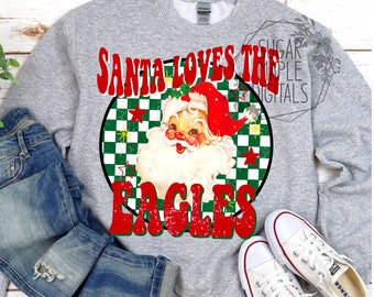 May include: A gray sweatshirt with a red, white, and green design featuring a cartoon Santa Claus and the text "Santa Loves The Eagles".