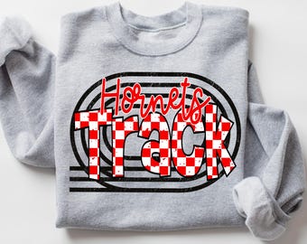 May include: A light gray crewneck sweatshirt featuring a graphic design with the red text Hornets above the word Track in a red and white checkered pattern, all layered over black oval track lines with a distressed texture.
