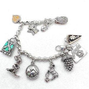 May include: A set of three ceramic mugs with a speckled, matte finish. The mugs are in shades of cream, light gray, and dark gray. Each mug has a simple, minimalist design and a rounded handle. The mugs are likely for coffee or tea.