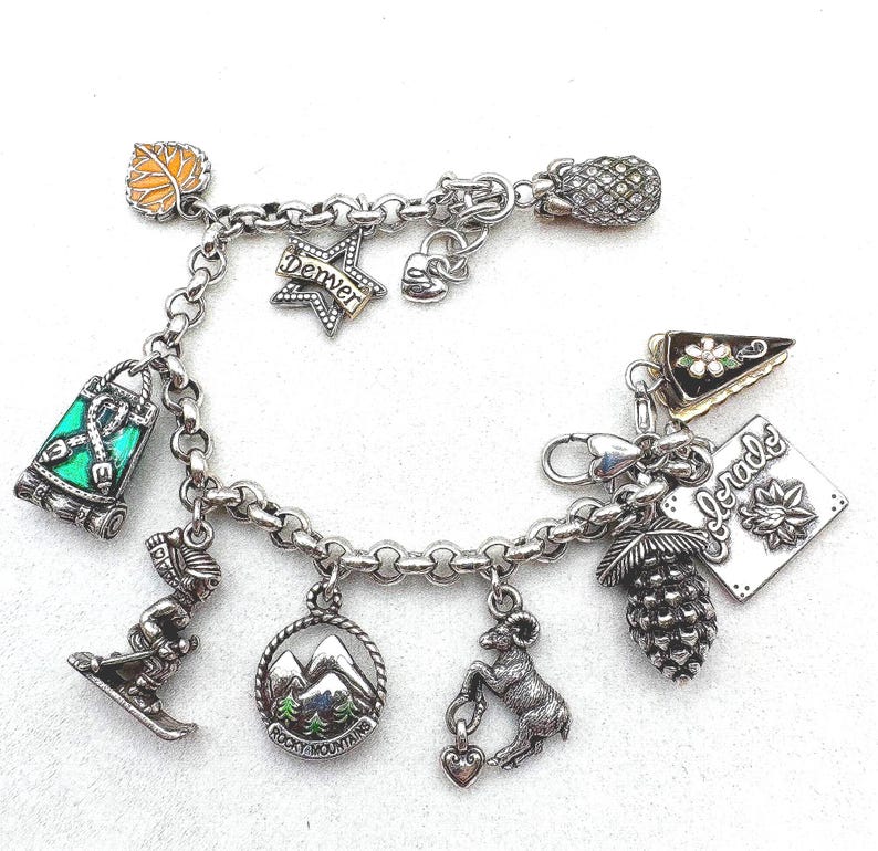 May include: A set of three ceramic mugs with a speckled, matte finish. The mugs are in shades of cream, light gray, and dark gray. Each mug has a simple, minimalist design and a rounded handle. The mugs are likely for coffee or tea.