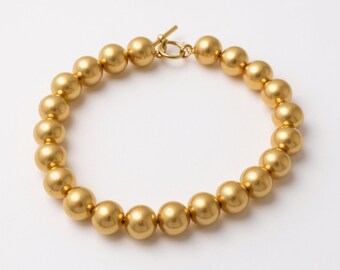Collar LOFT con cuentas de oro y collar grueso de oro.