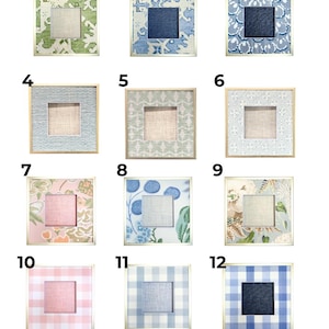May include: A collection of twelve square picture frames with various patterned designs. The frames have a square opening in the center and are surrounded by decorative borders in colors like green, blue, pink, and white. The frames are arranged in a grid.