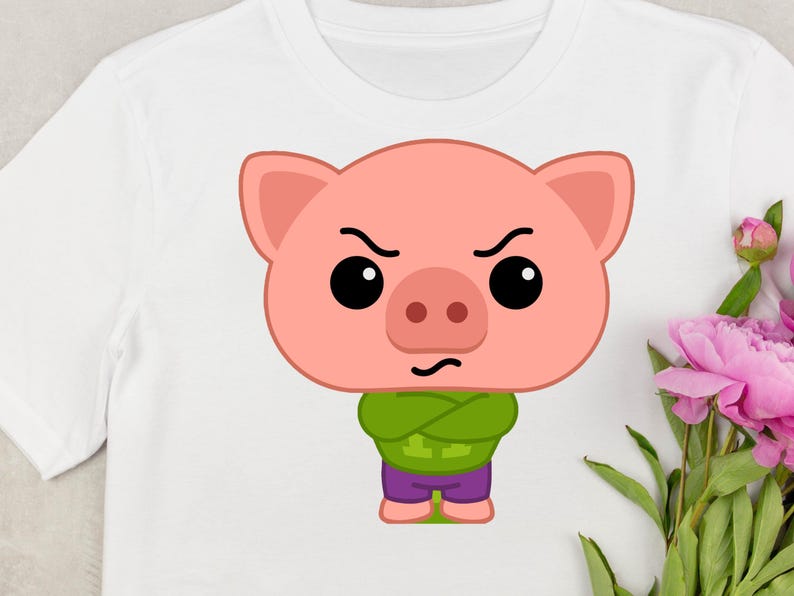 May include: White t-shirt featuring a cartoon pig with an angry expression. The pig is pink with black eyes, a green shirt, and purple pants. The design is centered on the shirt, with a floral arrangement in the background.