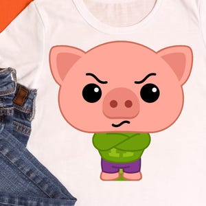 May include: White t-shirt featuring a cartoon pig with an angry expression. The pig is pink with black eyes, a green shirt, and purple shorts. The shirt is made of a soft material and is suitable for casual wear.
