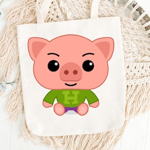 May include: A white tote bag featuring a cartoon pig illustration. The pig is pink with black eyes, a green shirt with a white "H", and purple shorts. The bag has two white handles and is set against a neutral background.