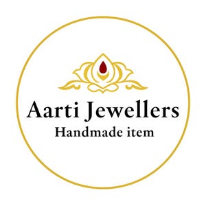 May include: Aarti Jewellers logo in a gold circle on a white background. The logo features a gold floral design with a red center and the text "Aarti Jewellers Handmade item" in black.
