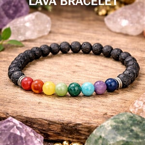 May include: A black lava bracelet with seven chakra beads in a rainbow of colors. The bracelet is displayed on a wooden surface with crystals and the text "Seven Chakra LAVA BRACELET".