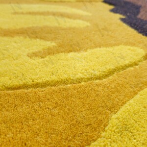 IN-108 Hand Tufted Sunflower Woolen Carpet for Floor Decor, Cozy Home,Bedroom, Courtyard, Living Room, Kids, Cabin, Bedroom, Reading Nook.
A vibrant sunflower-shaped wool rug handcrafted in rich yellow and brown tones, featuring realistic petal textures and a plush wool surface. Displayed in a bright minimalist room with indoor plants, natural sunlight, and a wooden bench, this handmade rug adds a cheerful botanical touch and cozy warmth to any modern living space.